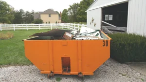pile of drywall, lumber, and renovation debris outside Kamloops home