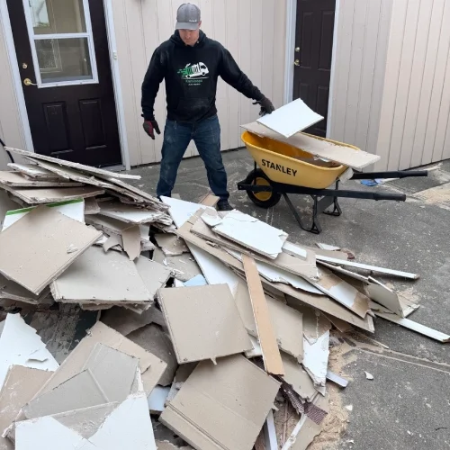 pile of drywall, lumber, and renovation debris outside Kamloops home