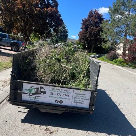 Kamloops junk removal truck loaded with branches and yard debris