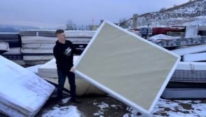 Kamloops Junk Haulers team member disposing of a mattress and box spring at a Kamloops waste facility