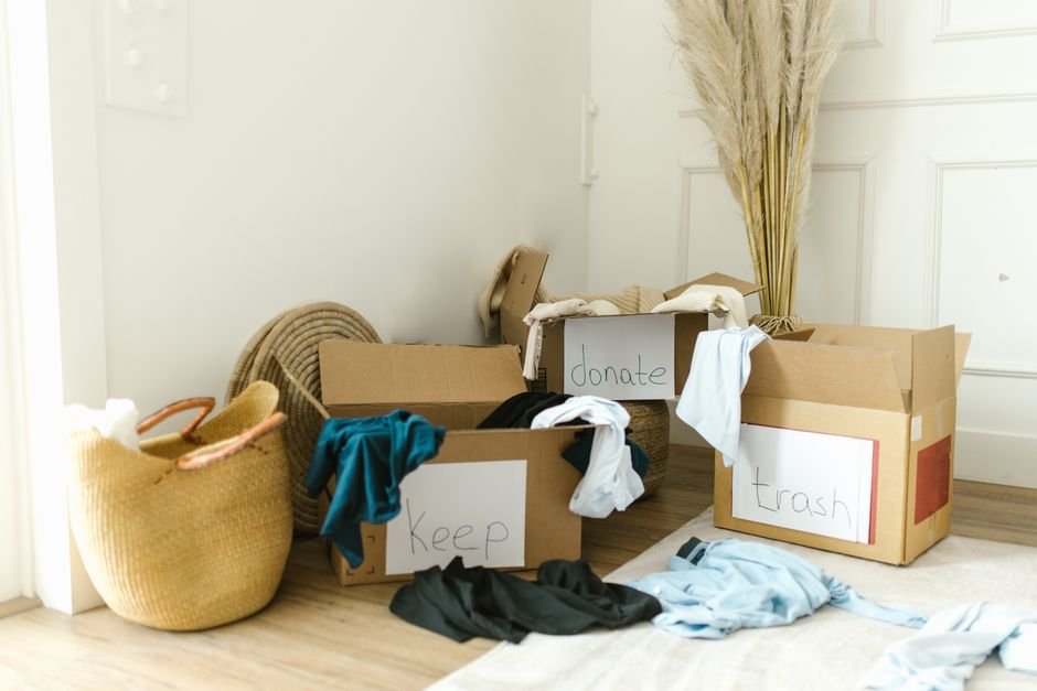 four sorting piles for garage cleanout with keep donate sell and junk sections