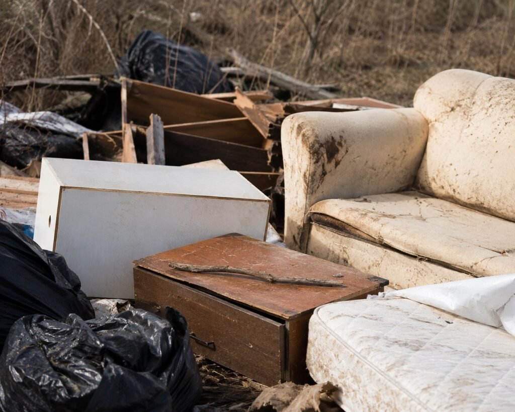Illegal dumping of unwanted furniture and junk in a rural area near Kamloops