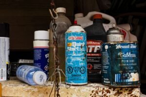 hazardous waste disposal Kamloops homeowner sorting paint cans and chemicals in garage