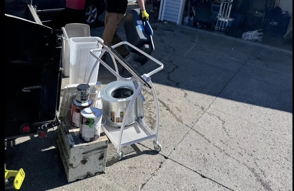 paint cans and chemical containers sorted for hazardous waste disposal in Kamloops garage